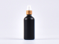 Preview: Schwarzglasflasche 100ml, mit Lotionspumpe Bambus