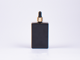 Schwarzglasflasche "Miro" 100ml, mit Pipette gold