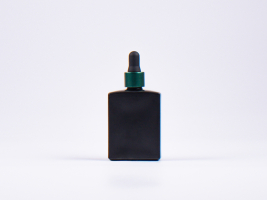 Schwarzglasflasche "Miro" 50ml, mit Pipette grün-matt